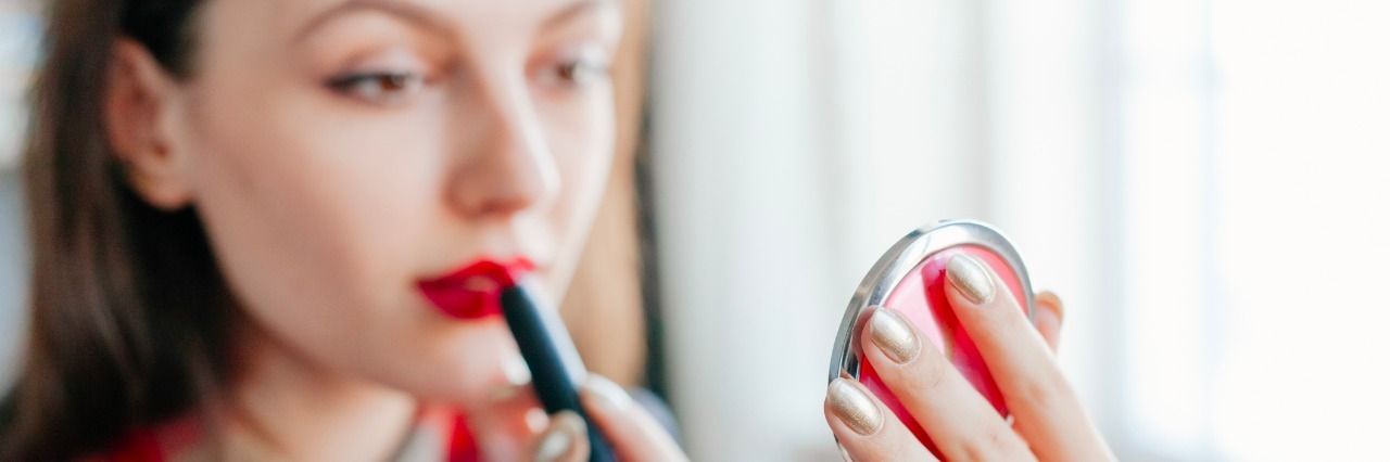 Eating Disorder and Body Dysmorphia: It Isn't About You a woman putting makeup on