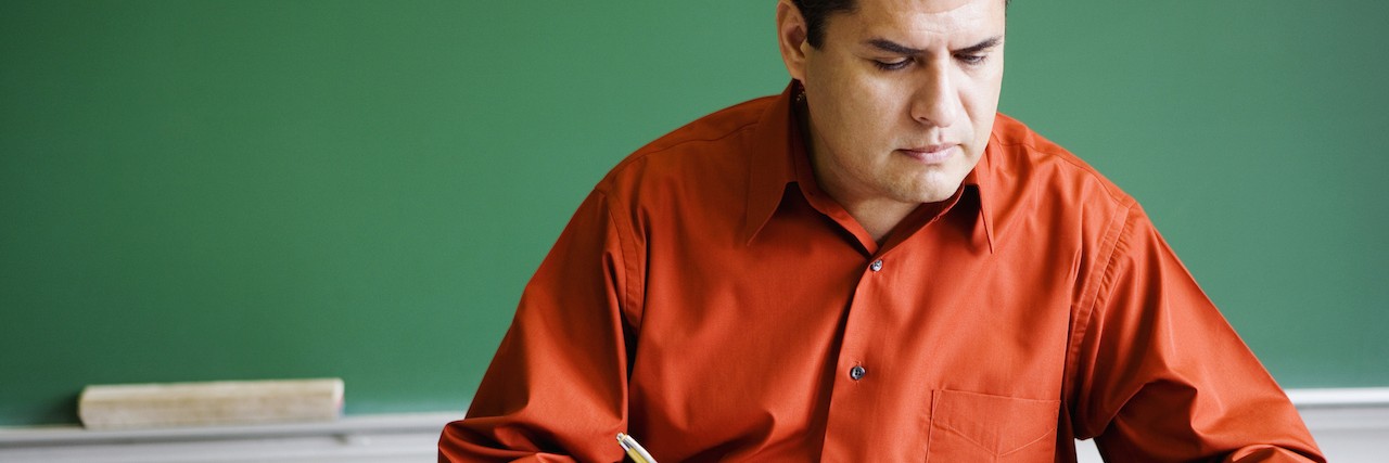 Teacher Writes to Those Affected by Generalized Anxiety Disorder teacher writing in a notebook