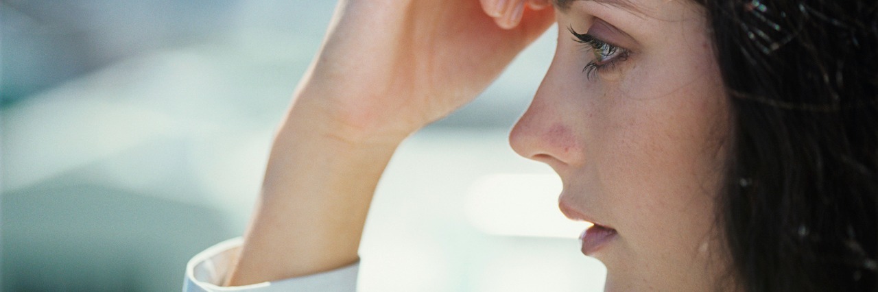 The True Meaning of 'Feeling Depressed' Young woman with hand on forehead