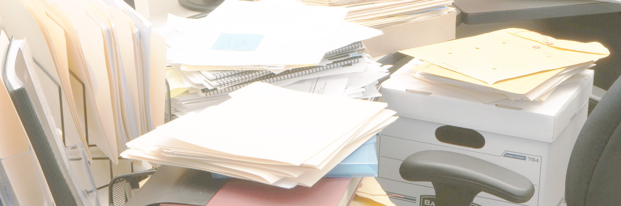 Feeling Like a Number as a Person Applying for Disability Benefits Stacks of files.