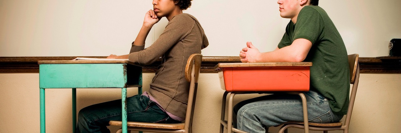 How to Cope With Panic Disorder When Going Back to School Two students sitting at desks in a classroom