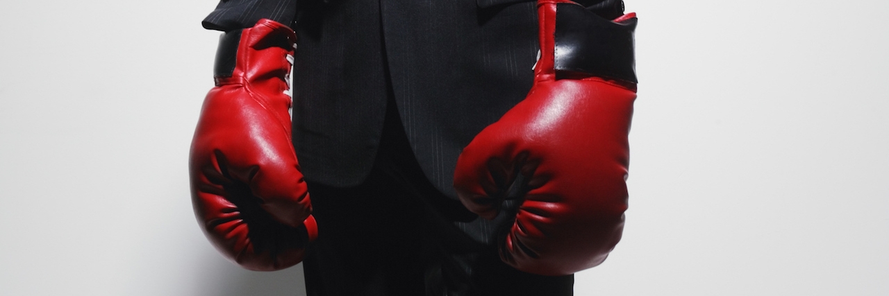 When I Realized That Depression Is a War, Not a Battle man in a suit with boxing gloves