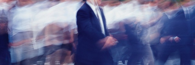 Business people crossing at the crosswalk, blurred motion