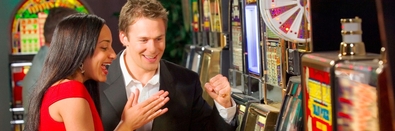 Couple playing slot machine