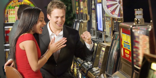 Couple playing slot machine