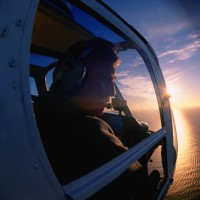 Helicopter pilot looking out of window