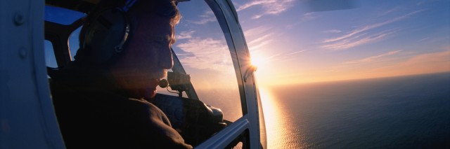 Helicopter pilot looking out of window