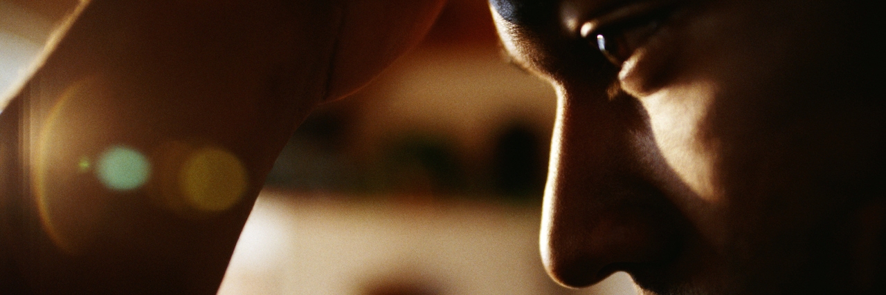 How to Explain What Depression Is and Is Not man in a dark room