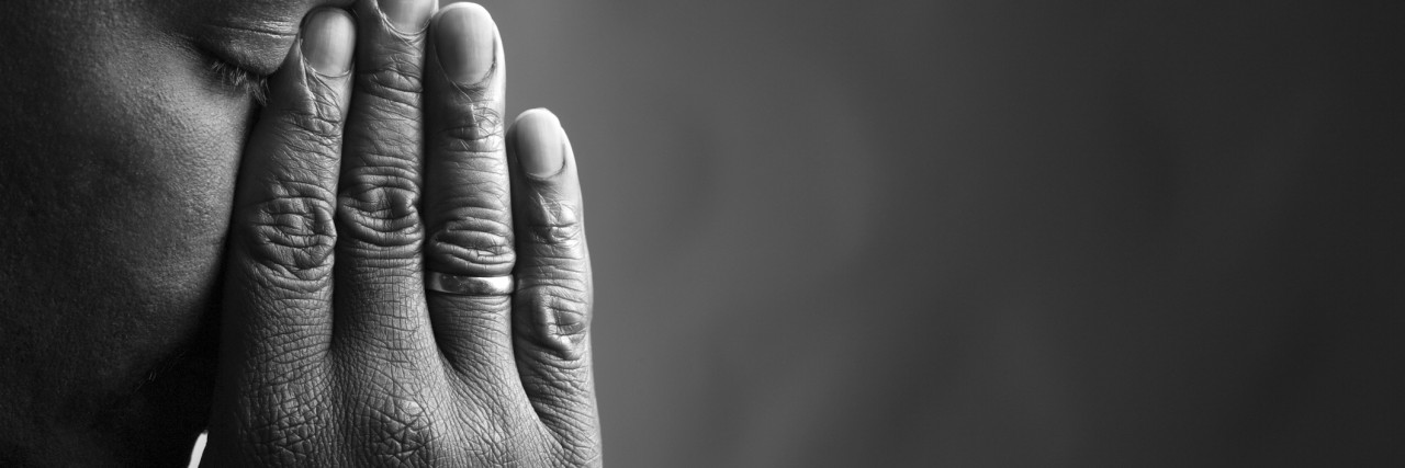 Child Loss: What No One Tells You About Grieving A black and white photo of a man with his hands to his face, upset