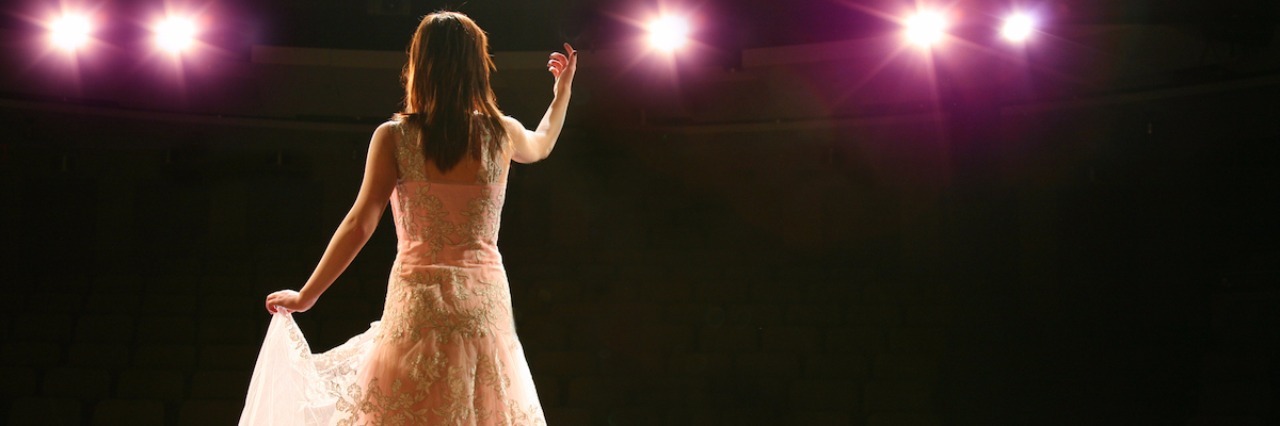 Why Life With Chronic Pain Is Like a Musical girl in long gown performing on stage