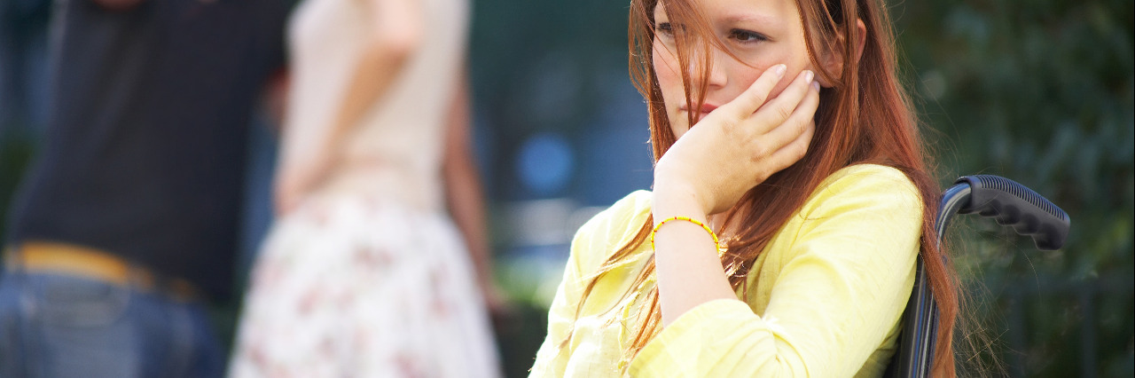 Being Treated as Invisible Because I Have a Disability Young woman in a wheelchair feeling excluded.