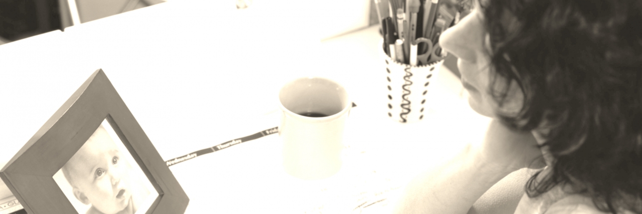 Why a Calendar is Not the Same After Losing a Child Businesswoman With a Photograph of a Baby