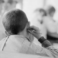 Black and white photo of boy at school sitting at desk