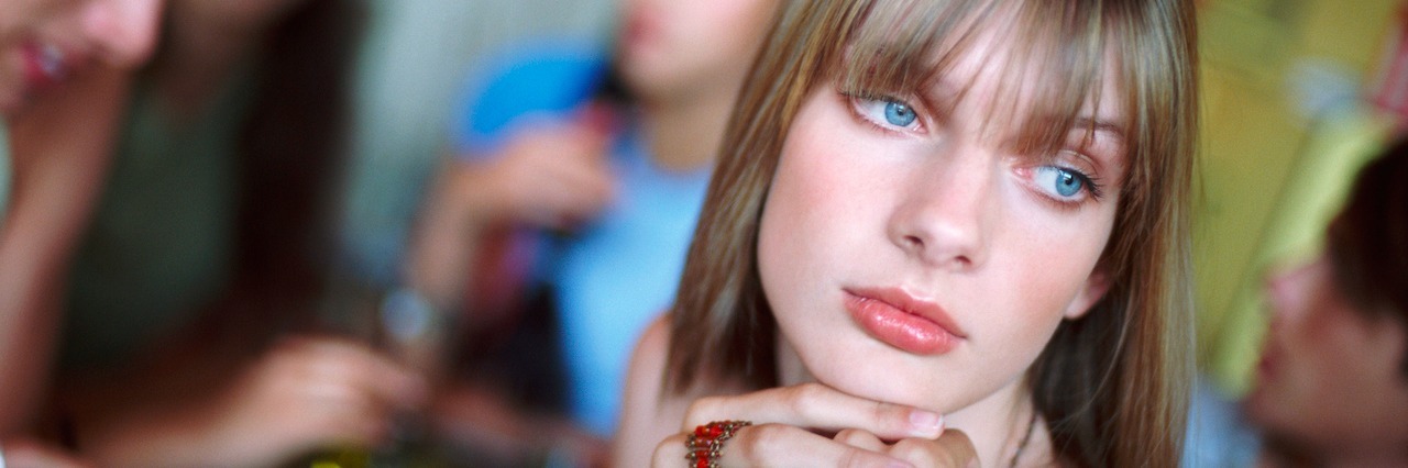 The Mental Battle of Anxiety and Depression Versus Making Friends teenage girl looking lonely at a cafe