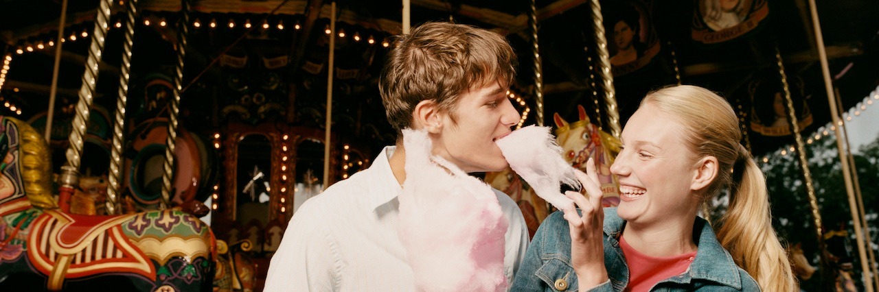 Tips for Dating Someone With Sexual Assaul PTSD couple standing in front of a ferris whieel