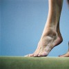Feet of gymnast on balance beam