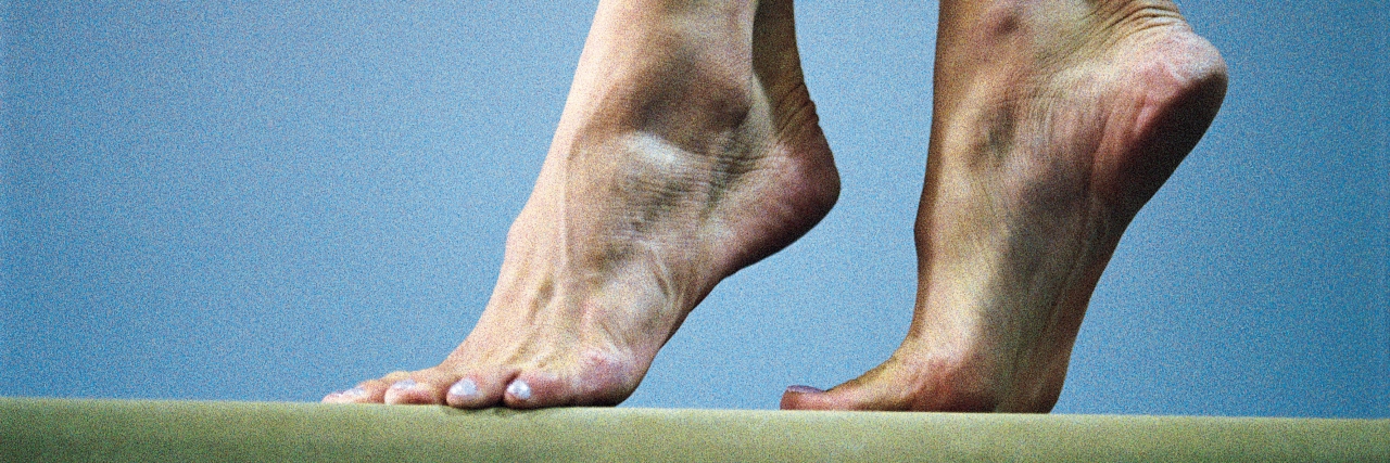 Finding Balance as a Parent Feet of gymnast on balance beam