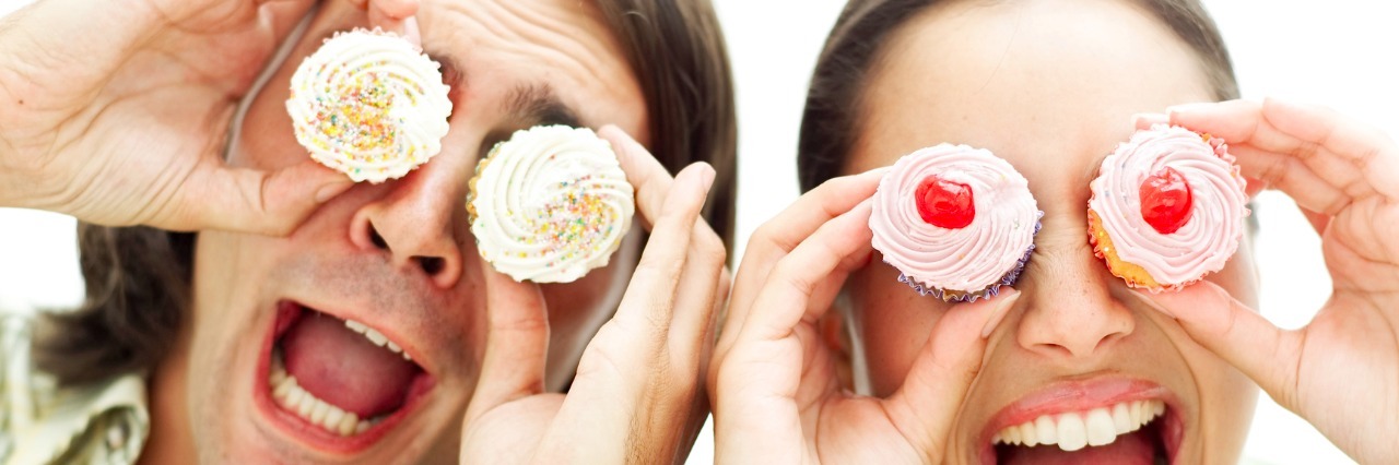 Cupcakes and Humor: Ingredients in My Marriage With Anxiety portrait of a young couple holding cupcakes up to their eyes