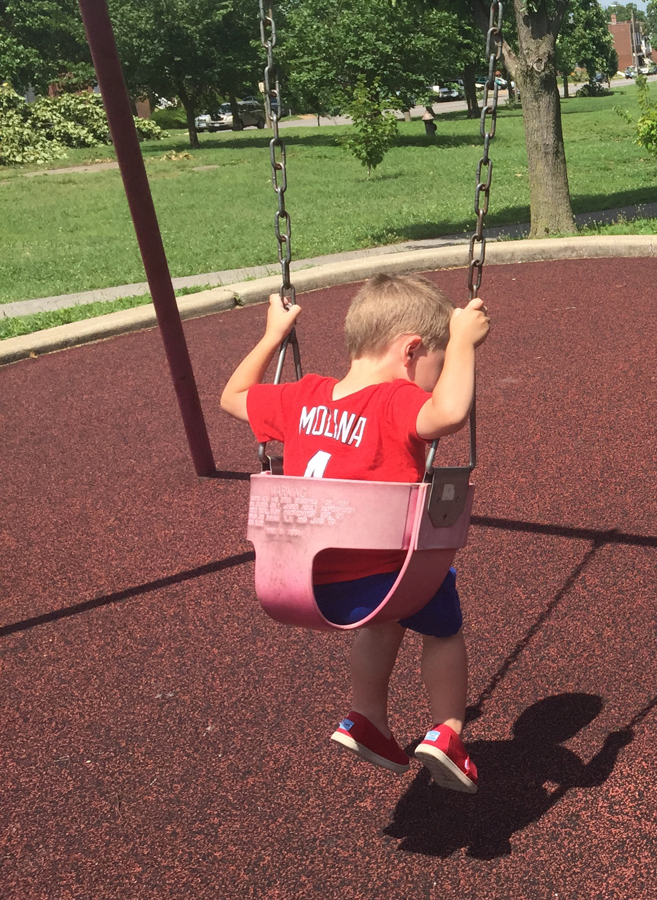 The author's son wearing a Yadier Molina shirt on the swing