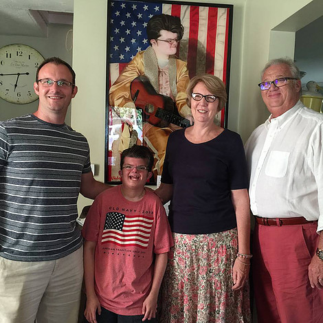 Evan Hildebrandt, Logan Brinson and Sue and Lee Schaefer pose with Logan's portrait.