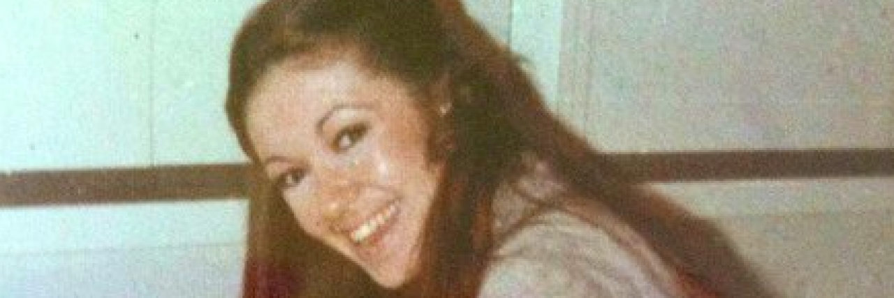 When I Remember My Mom’s Life as a Hair Stylist Before She Died From Cancer Danielle Dayney's mother smiling while washing woman's hair in sink