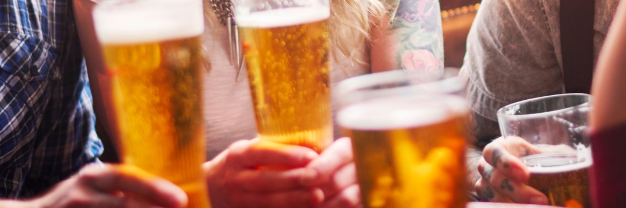 When I'm Pressured to Drink With Chronic Fatigue Syndrome beer glasses on table surrounded by friends