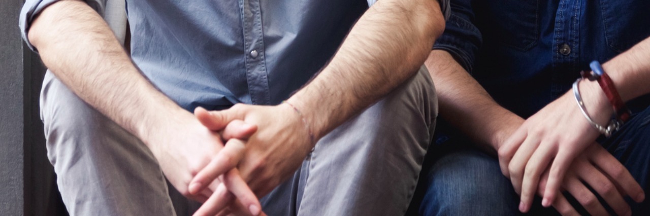Advice for Friends Who Want to Help Someone With Pain Couple of young men talking on the stairs of an office