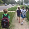 three kids walking to school