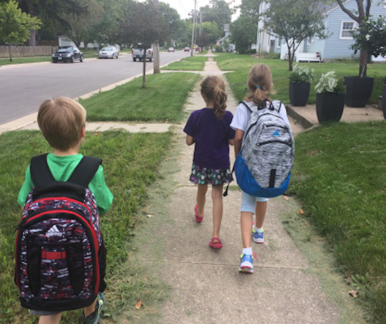 three kids walking to school