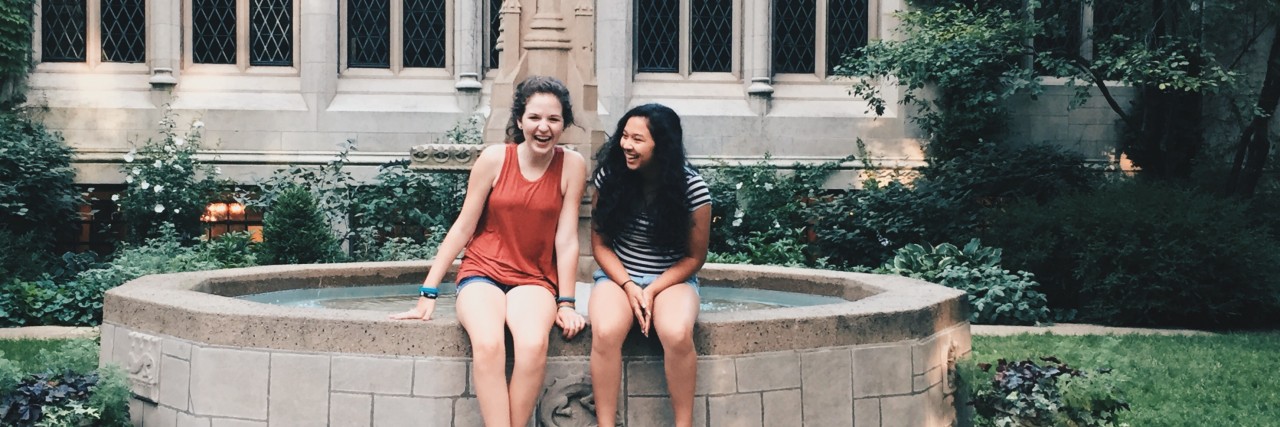 Opening Up to Friends About My Chronic Pain The author with a friend, sitting on the edge of a fountain in front of a building