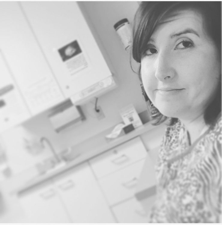 black and white photo of woman in a medical office