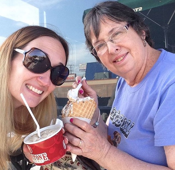 woman and adult daughter drinking soda and eating ice cream
