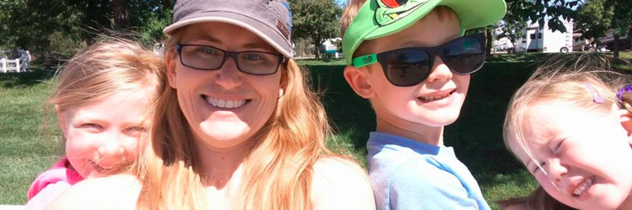 How Much Should You Tell Your Kids About Lyme Disease woman and her three young kids at a park