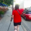 woman walking down street with a cane