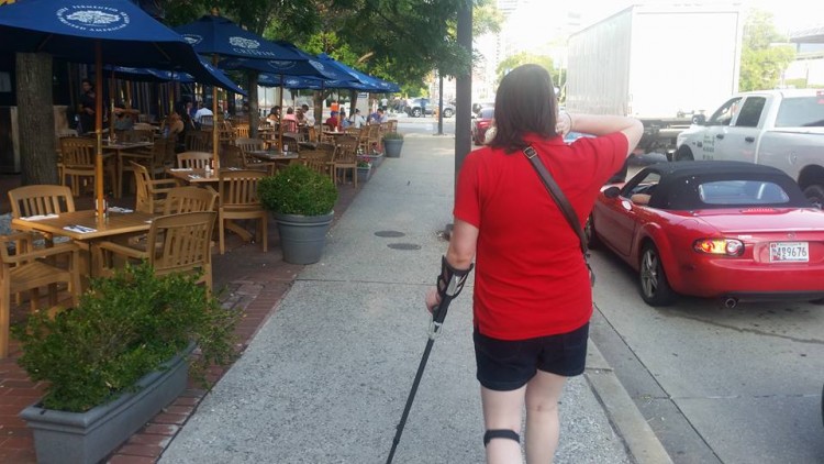 woman walking down street with a cane