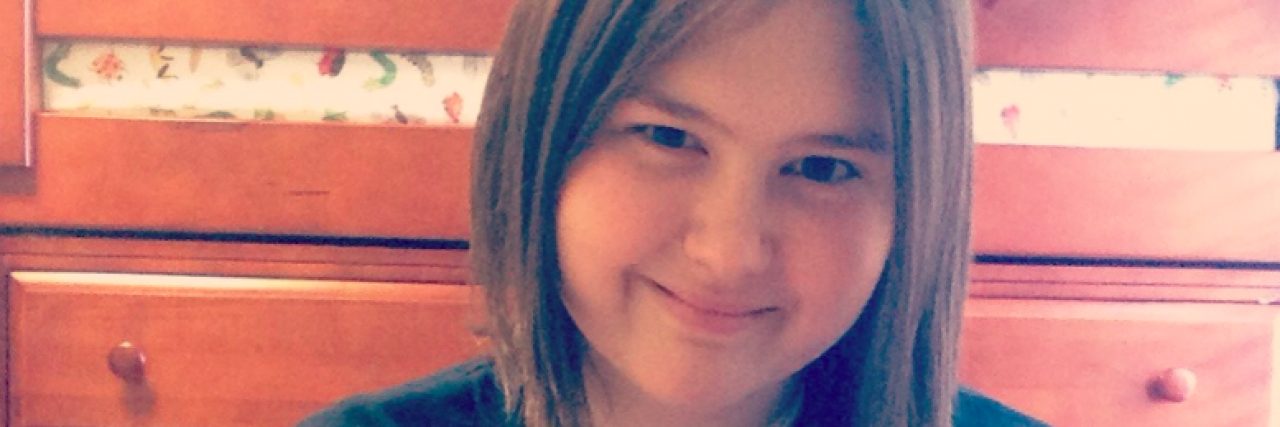 What You Won't Learn About Gastroparesis From the Medical Definition Young woman holding sign that says "Hey Gastroparesis. Quite while you can. You're NEVER going to beat her. She is too strong for you!"