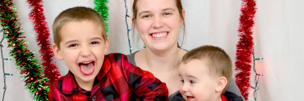 The Crucial Point That's Being Missed in the EpiPen Conversation mom sitting on floor with two boys in pajamas