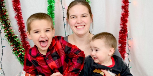 The Crucial Point That's Being Missed in the EpiPen Conversation mom sitting on floor with two boys in pajamas