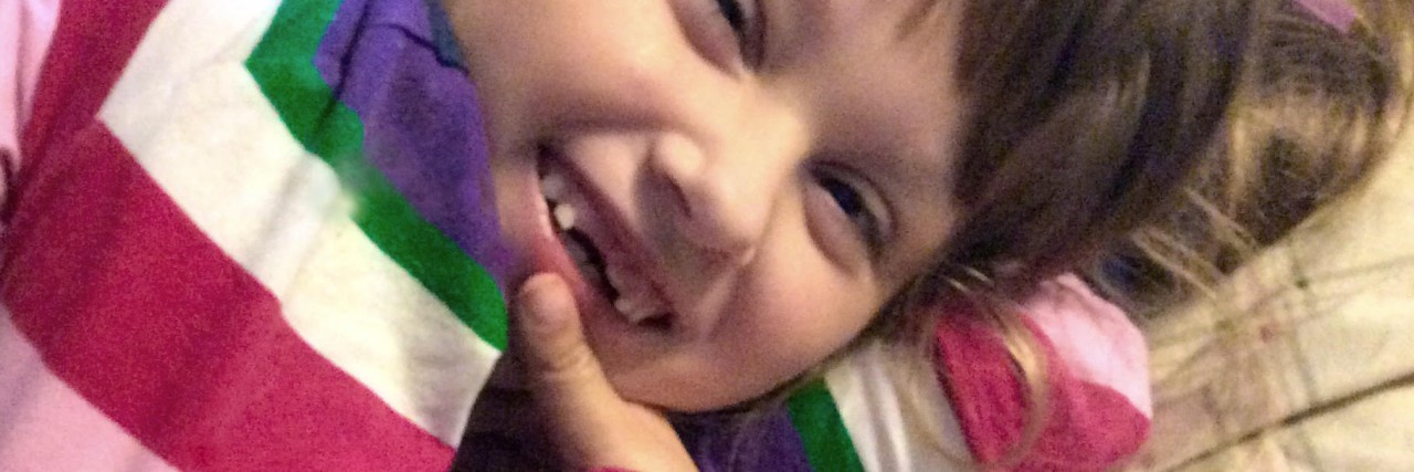 Mornings of Parents of a Medically Fragile Child With Phelan McDermid little girl smiling in crib