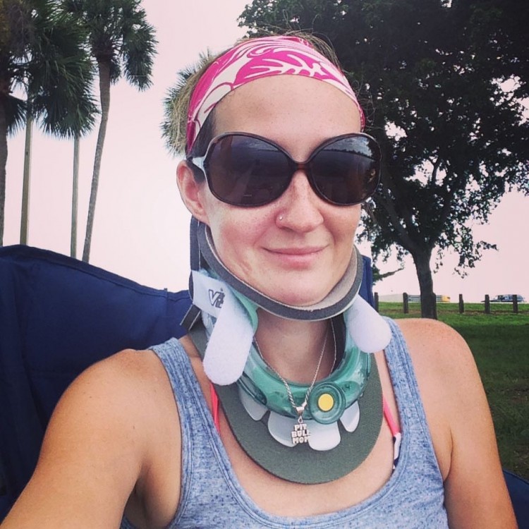 woman wearing a neck brace and sunglasses