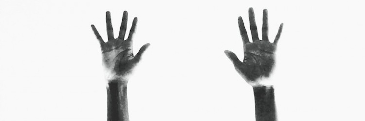 two hands reaching up