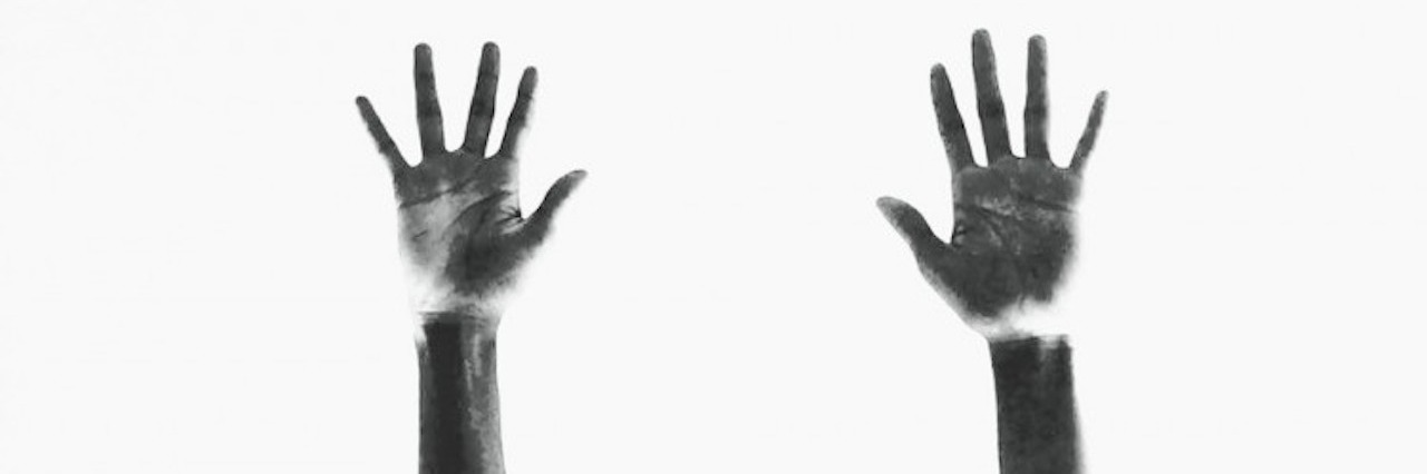 Healing and Processing Racial Trauma in the Black Community two hands reaching up