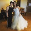 bride in wedding dress next to woman standing with crutch