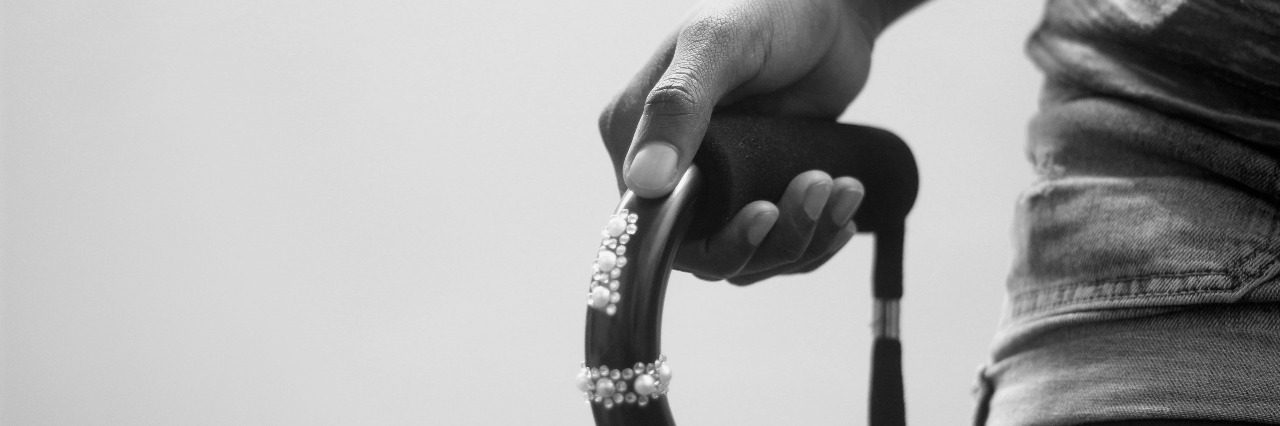 How to Feel Confident When Using a Cane black and white photo of hand holding a cane