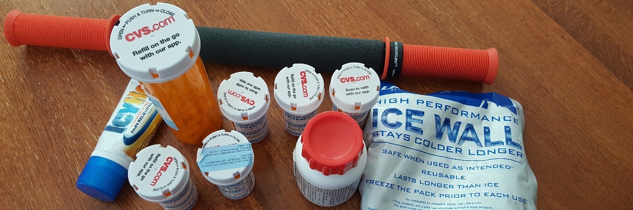 A Lupus Patient's Perspective on the Opioid Crisis bottles of pills sitting on wood surface