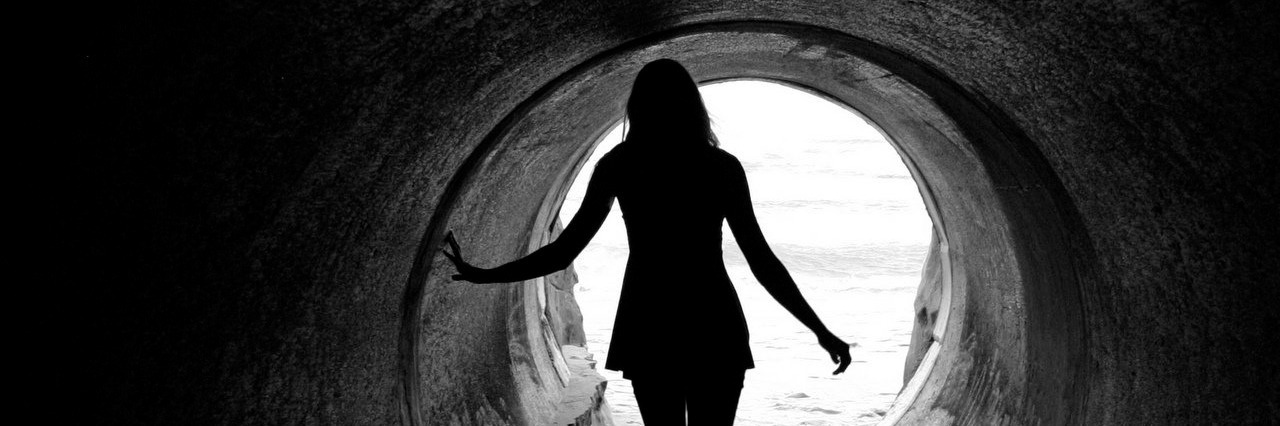 woman walking in tunnel