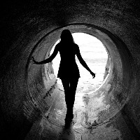 woman walking in tunnel