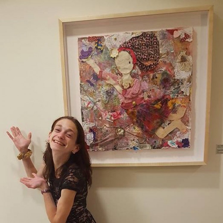 young woman posing with her painting