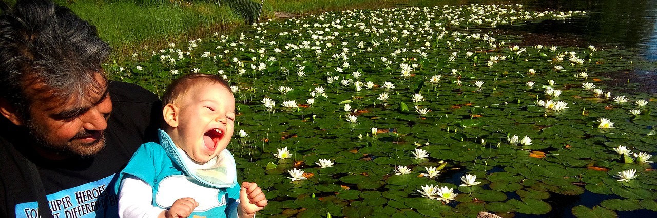 Parenting a Child With Allan-Herndon-Dudley Syndrome: What to Know Veronica's son smiling with his father outside