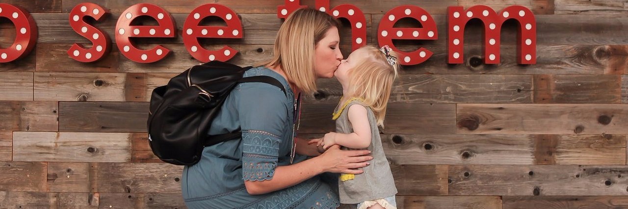 Questions Every Parent Should Ask at an IEP Meeting mother kissing her young daughter (photo credit: Mily Cooper Photography)